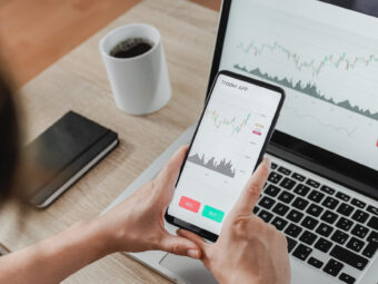 Forex trader using crypto exchange mobile phone app for investment and stock market analysis at hedge fund office - Focus on screen